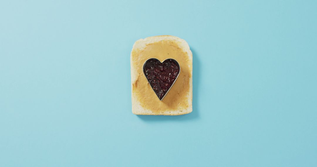 Heart-shaped Jam on Peanut Butter Toast on Light Blue Background - Free Images, Stock Photos and Pictures on Pikwizard.com