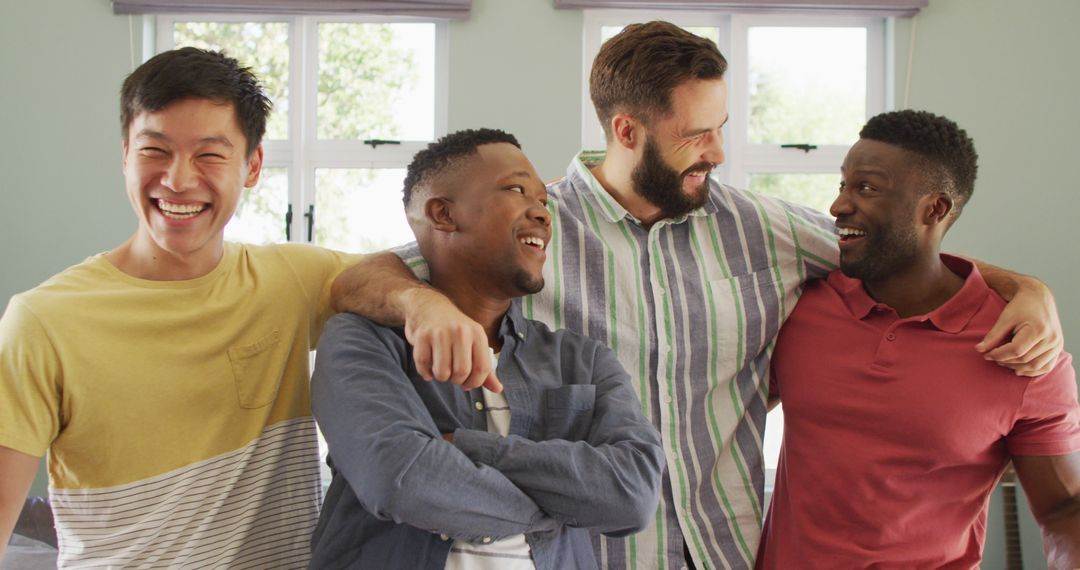 Portrait of happy diverse male friends embracing in living room - Free Images, Stock Photos and Pictures on Pikwizard.com