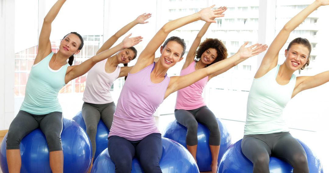 Group of Women Practicing Pilates on Exercise Balls - Free Images, Stock Photos and Pictures on Pikwizard.com