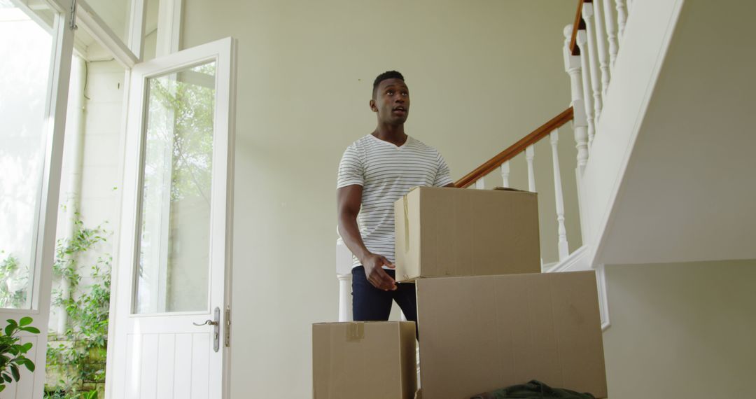 Man Carrying Moving Boxes in Bright Interior - Free Images, Stock Photos and Pictures on Pikwizard.com