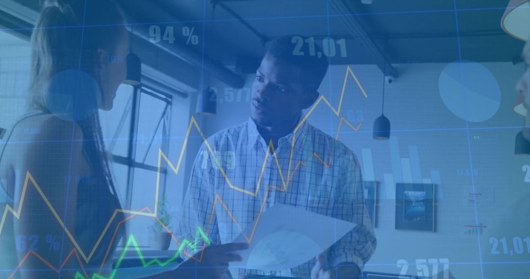 Team Analyzing Printed and Digital Sales Data in Modern Office