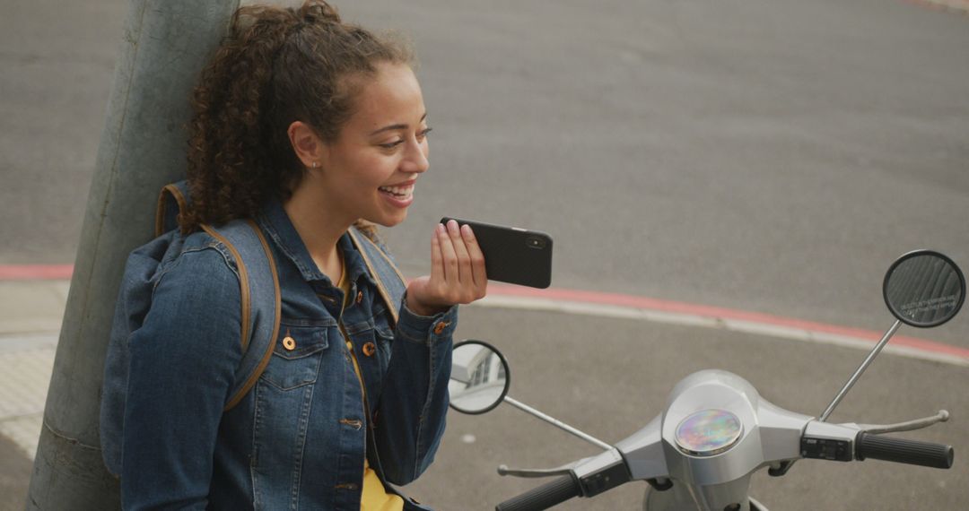 Young woman talking on smartphone next to scooter - Free Images, Stock Photos and Pictures on Pikwizard.com
