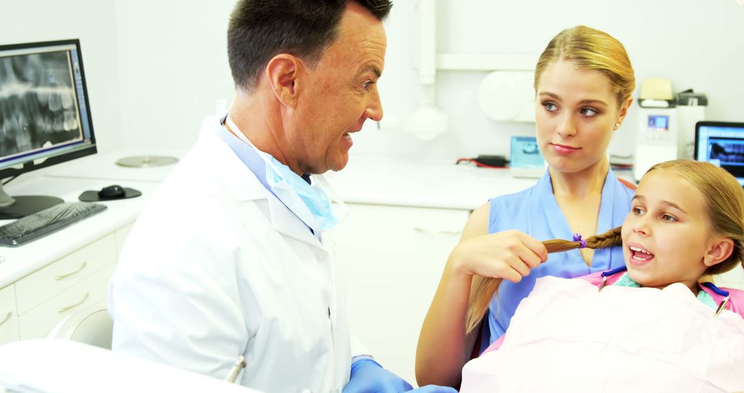 Father Comforting Daughter During Dental Examination - Free Images, Stock Photos and Pictures on Pikwizard.com