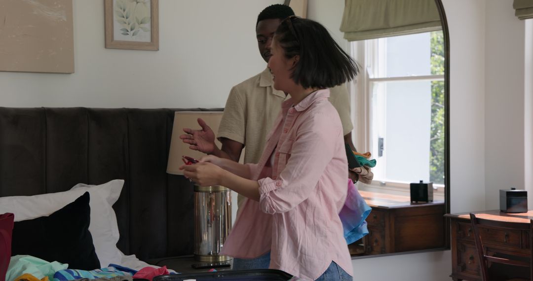 Multiracial Couple Enjoying Wardrobe Selection at Home