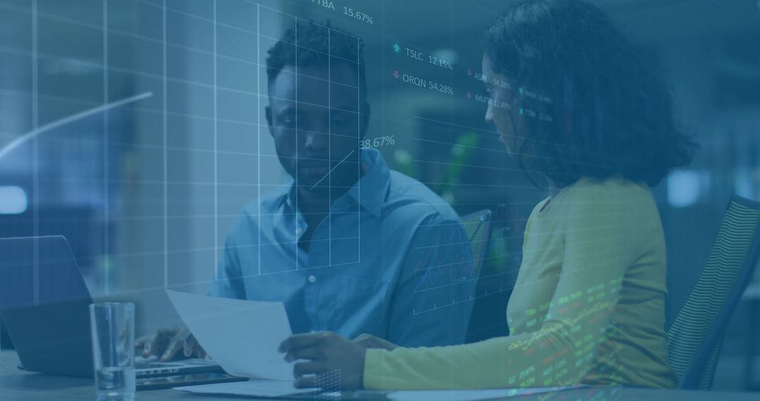 Colleagues Analyzing Data and Engaging in Discussion at Workplace