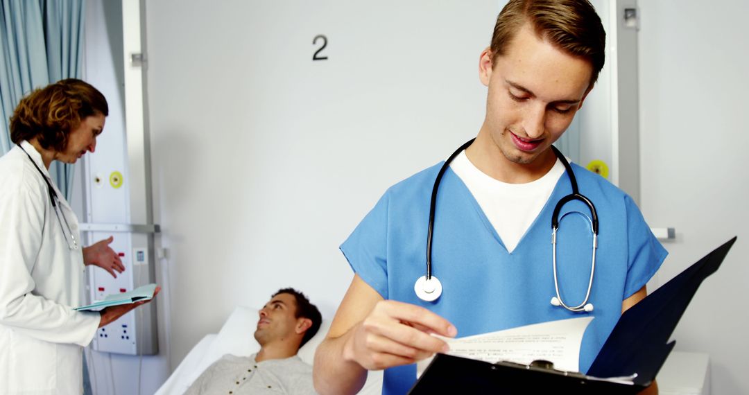 Medical Team Reviewing Patient Chart in Hospital Room - Free Images, Stock Photos and Pictures on Pikwizard.com