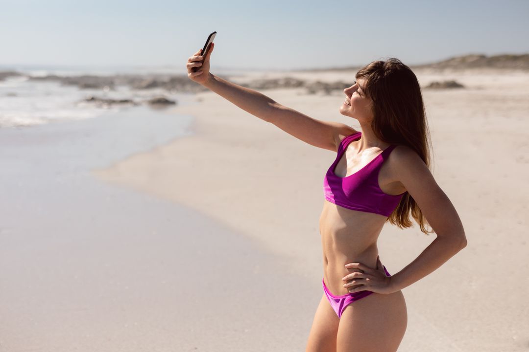 Young Woman in Bikini Taking Selfie on Sunny Beach - Free Images, Stock Photos and Pictures on Pikwizard.com