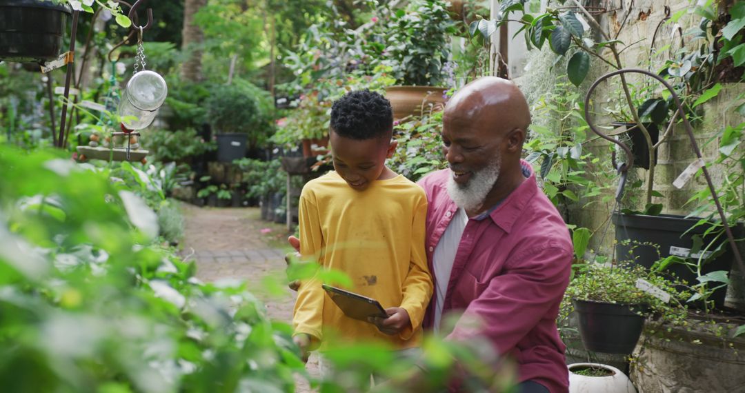 Grandfather and Grandson Enjoying Time in Garden, Surrounded by Greenery - Free Images, Stock Photos and Pictures on Pikwizard.com