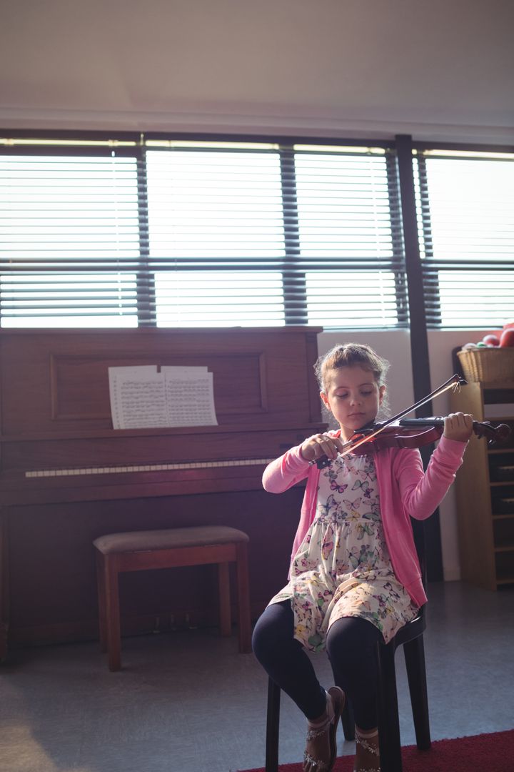 Young Girl Practicing Violin in Music Classroom - Free Images, Stock Photos and Pictures on Pikwizard.com