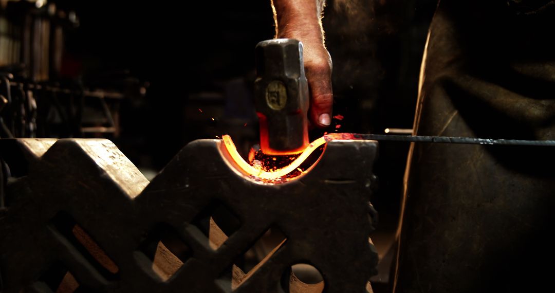 Blacksmith Crafting Glowing Iron with Hammer in Workshop