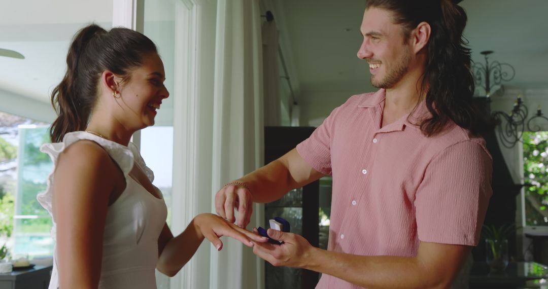 Man Gifting a Romantic Surprise to Smiling Woman at Home