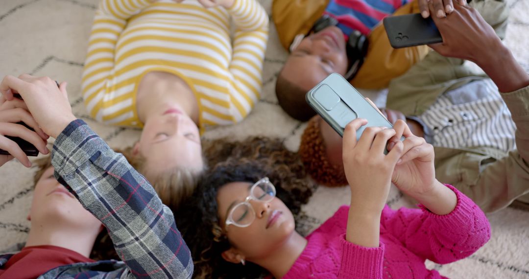 Diverse Group of Friends Lying on Floor and Using Smartphones - Free Images, Stock Photos and Pictures on Pikwizard.com