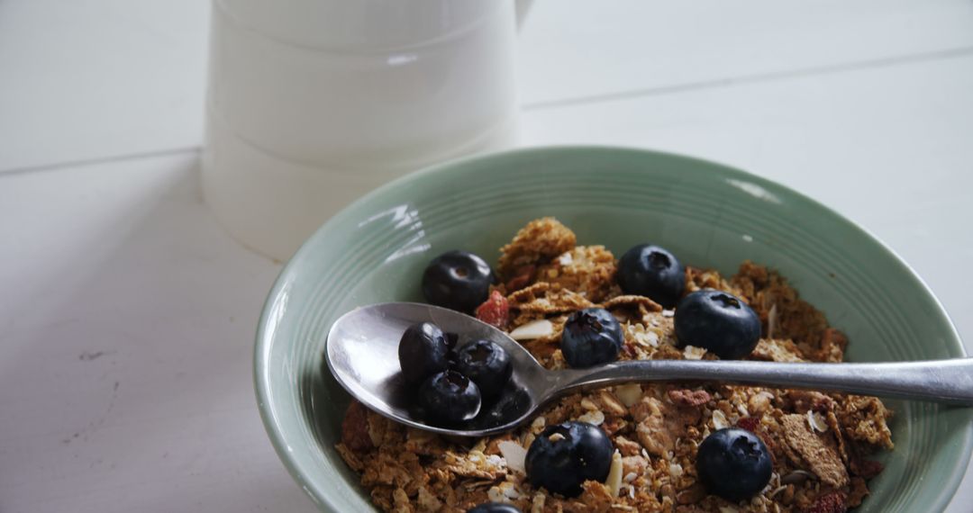 Healthy Breakfast Bowl with Granola, Blueberries, and Spoon - Free Images, Stock Photos and Pictures on Pikwizard.com