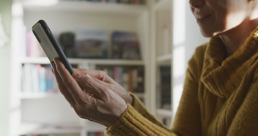 Woman Using Smartphone in Cozy Home Setting - Free Images, Stock Photos and Pictures on Pikwizard.com