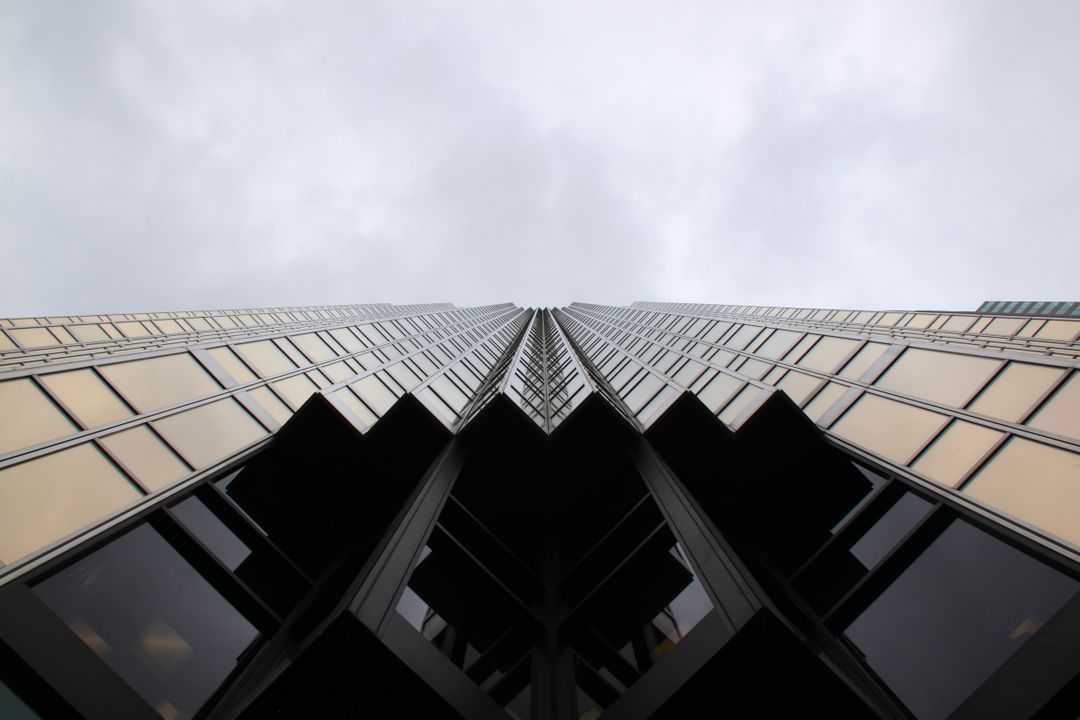 Abstract View of a Modern Skyscraper from Below Against a Cloudy Sky - Free Images, Stock Photos and Pictures on Pikwizard.com