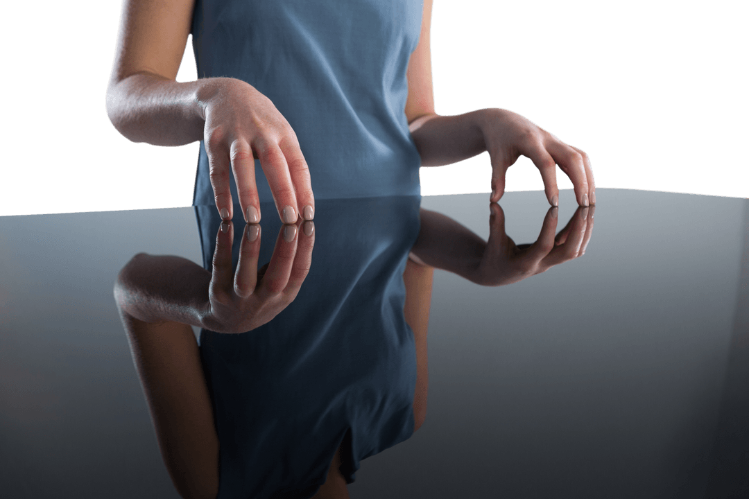 Transparent Businesswoman's Hands Reflecting on Glass Table