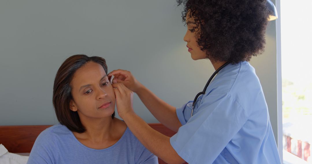 Female Nurse Assisting Woman with Ear Examination at Home - Free Images, Stock Photos and Pictures on Pikwizard.com