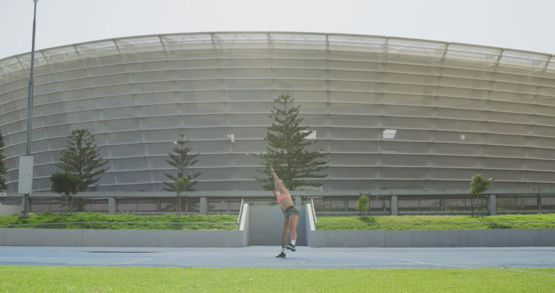 Female Javelin Thrower Practicing at Stadium Field