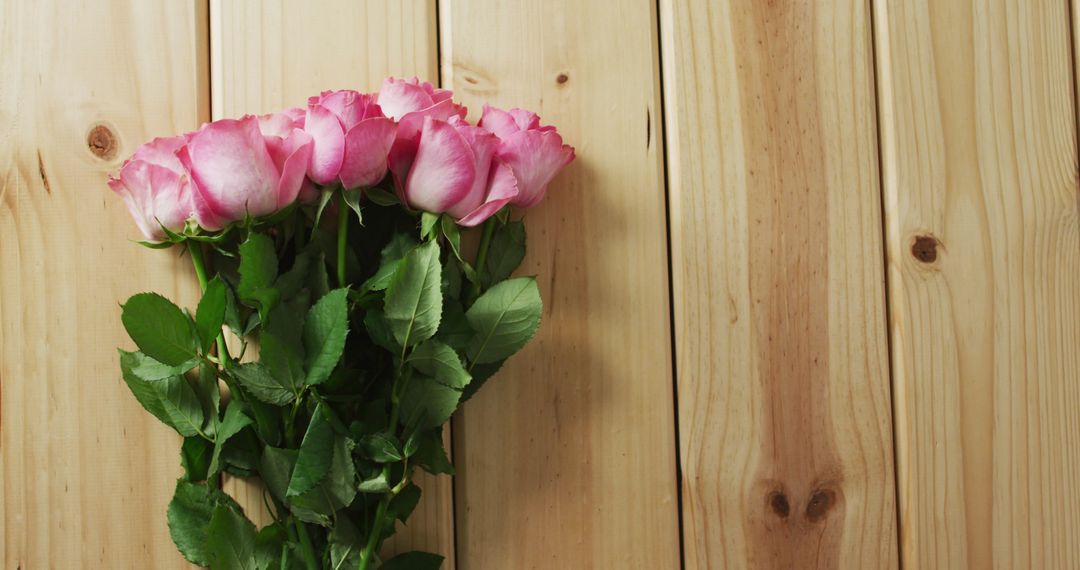 Elegant Pink Roses Bouquet on Rustic Wooden Surface