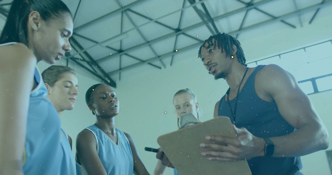 Basketball Coach Leading Timeout Huddle with Players Holding Clipboard in Gym