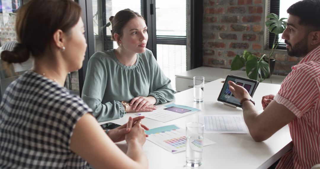 Creative Team Discussing Mobile App Design in Modern Office