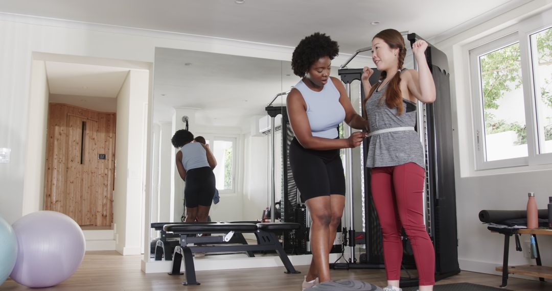 Personal Trainer Measuring Client's Progress at Gym