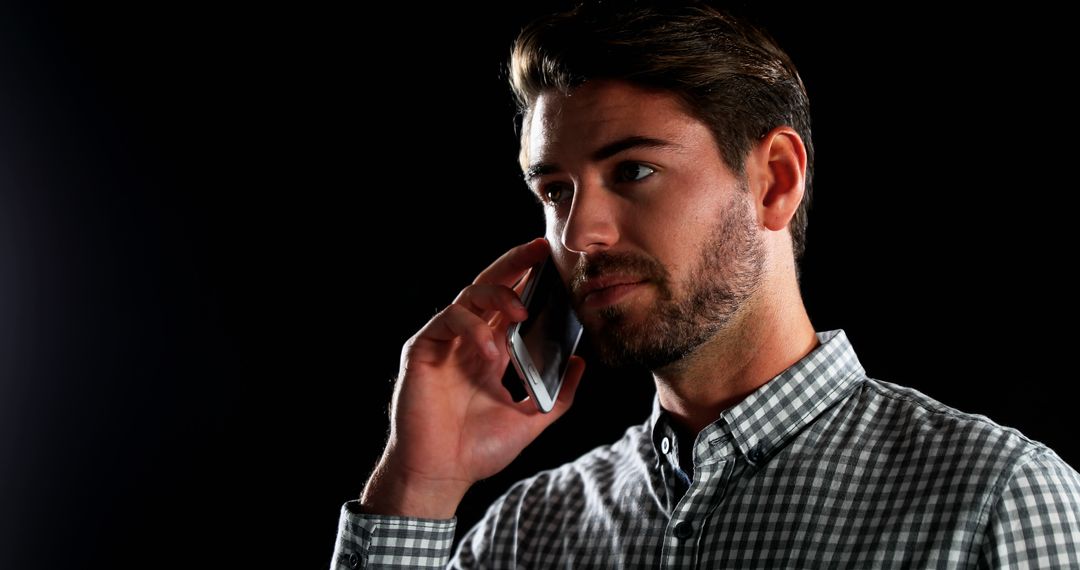 Man Talking on Smartphone in Dark Background - Free Images, Stock Photos and Pictures on Pikwizard.com