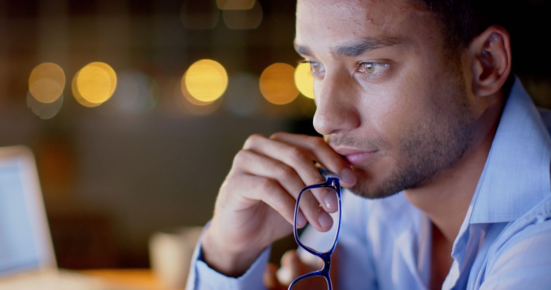 Thoughtful Man Contemplating Work At Night With Blurred City Lights - Free Images, Stock Photos and Pictures on Pikwizard.com