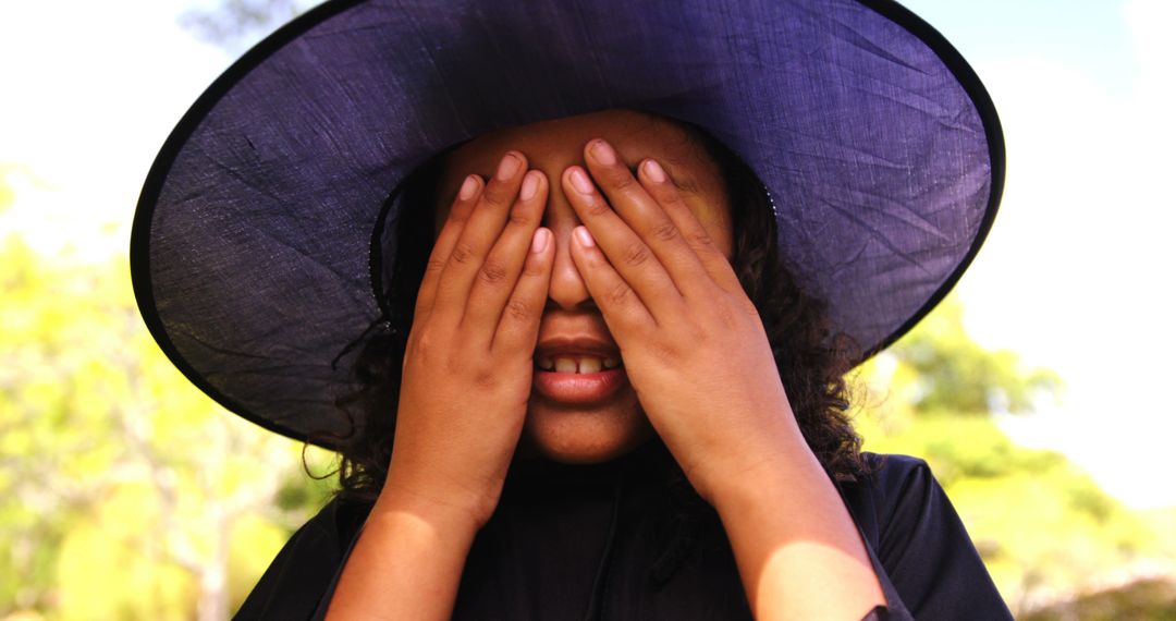 Young Girl Covering Eyes with Hands Dressed as Witch - Free Images, Stock Photos and Pictures on Pikwizard.com