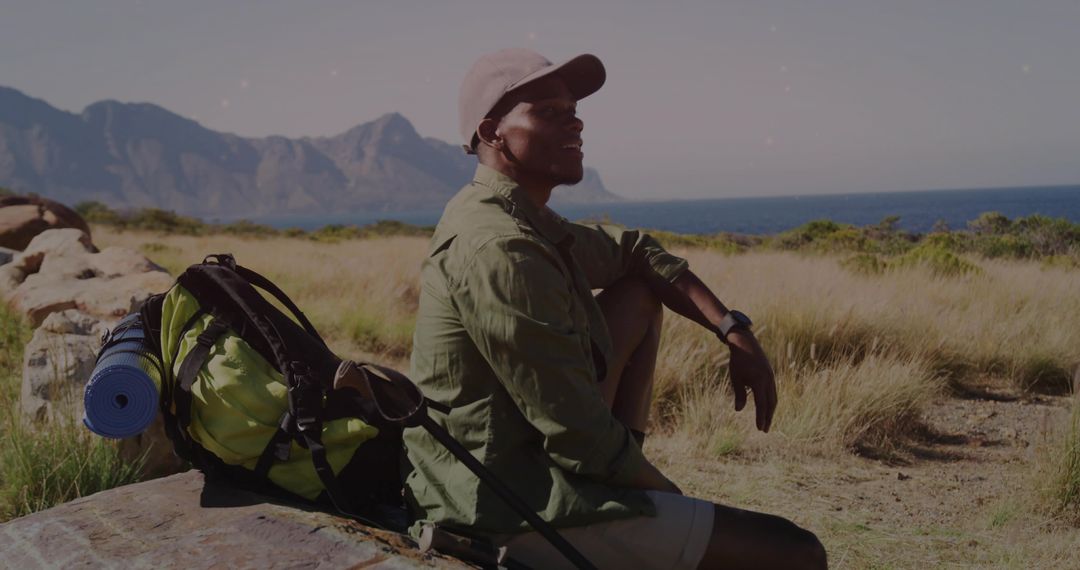 Hiker Enjoying Mountain and Ocean Views on Coastal Ledge