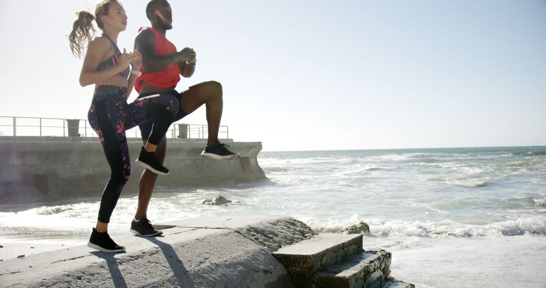 Motivated athletes exercising by the coast during sunrise - Free Images, Stock Photos and Pictures on Pikwizard.com