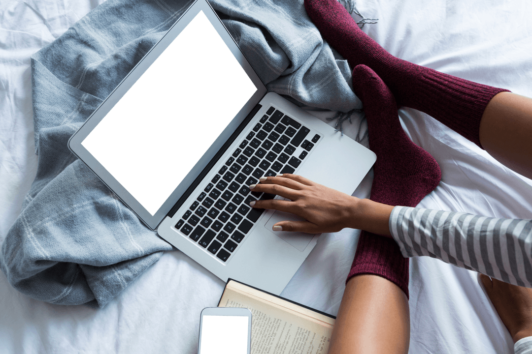 Woman Relaxing with Laptop on Bed Using Drone Photography Concept