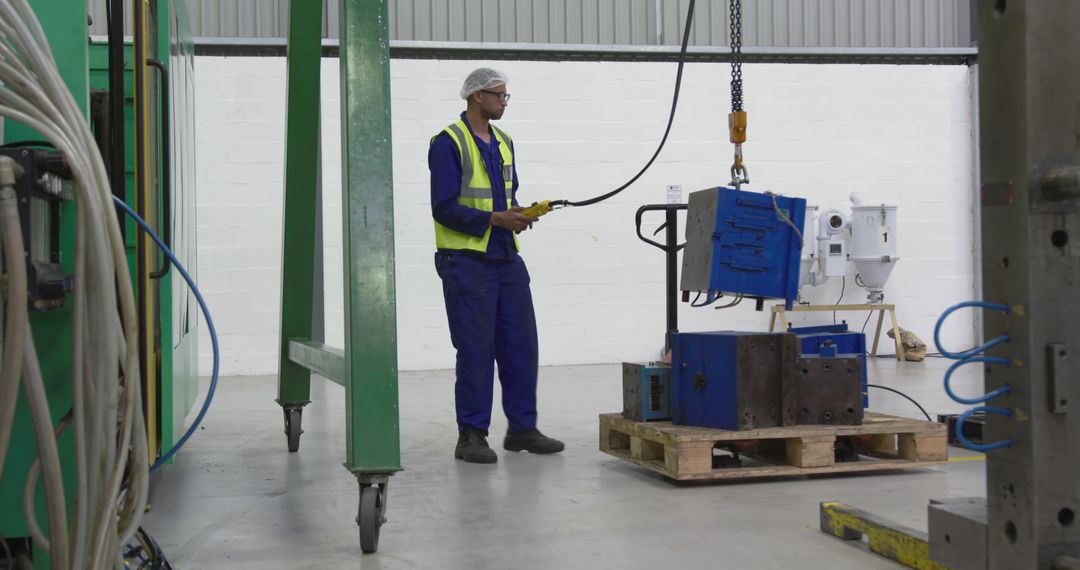 Factory Worker Operating Overhead Crane in Manufacturing Facility - Free Images, Stock Photos and Pictures on Pikwizard.com