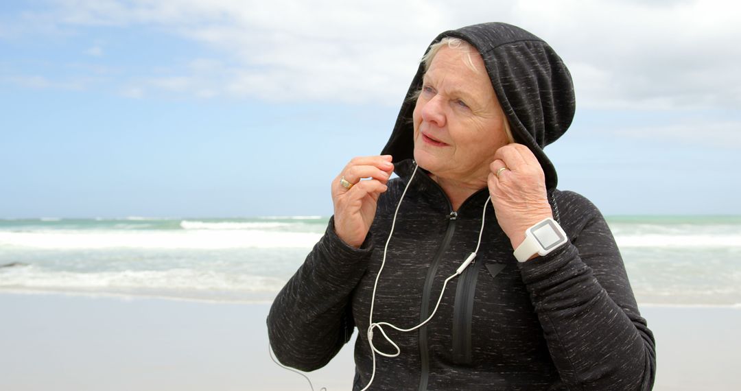 Senior Woman Preparing for Beach Run with Earbuds - Free Images, Stock Photos and Pictures on Pikwizard.com