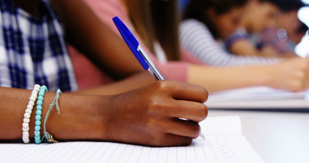 Students Writing in Notebooks During Classroom Activity - Free Images, Stock Photos and Pictures on Pikwizard.com