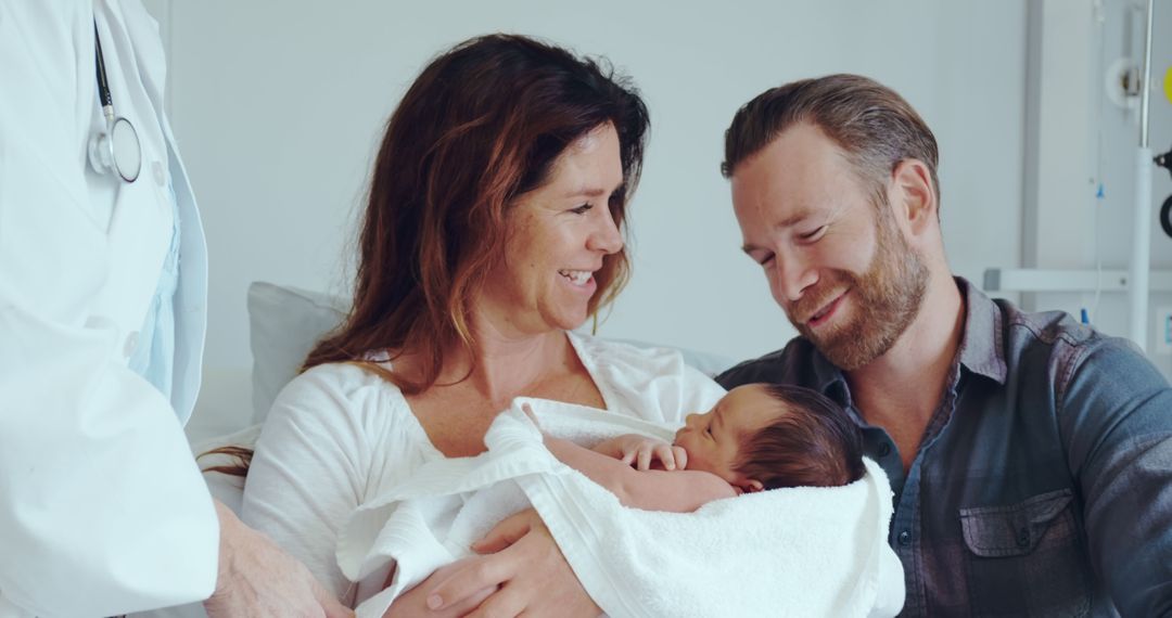 Smiling Parents Holding Newborn Baby at Hospital - Free Images, Stock Photos and Pictures on Pikwizard.com