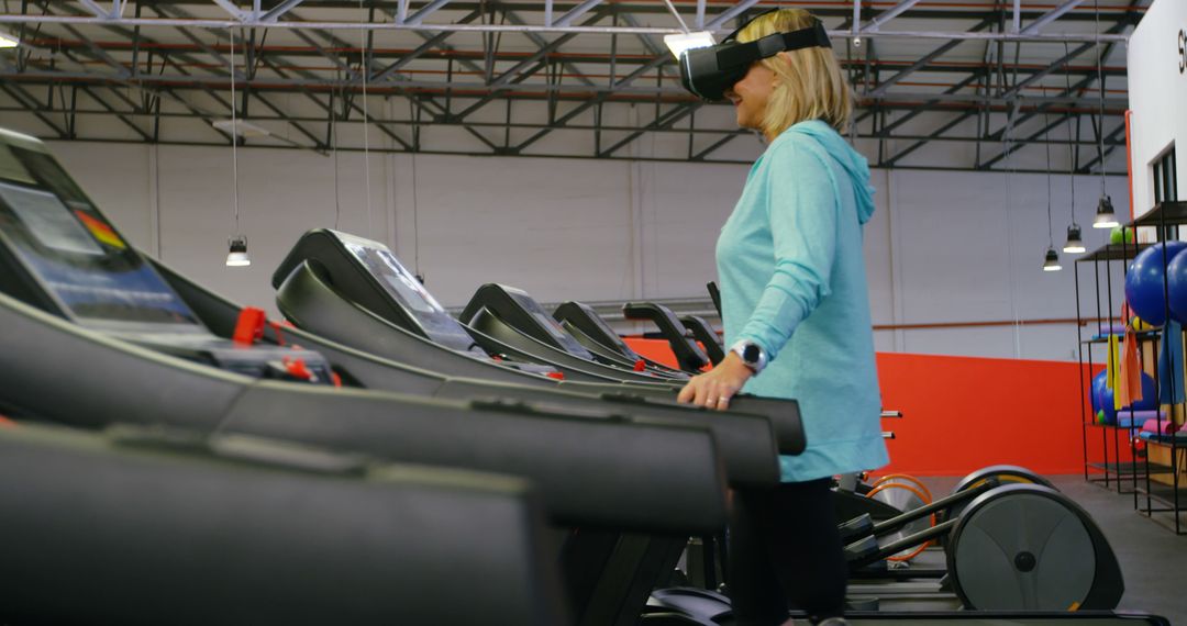 Woman Utilizing Virtual Reality Headset on Treadmill in Modern Gym - Free Images, Stock Photos and Pictures on Pikwizard.com