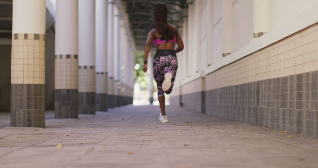 Fit Woman Running Through Urban Corridor for Fitness Exercise - Free Images, Stock Photos and Pictures on Pikwizard.com