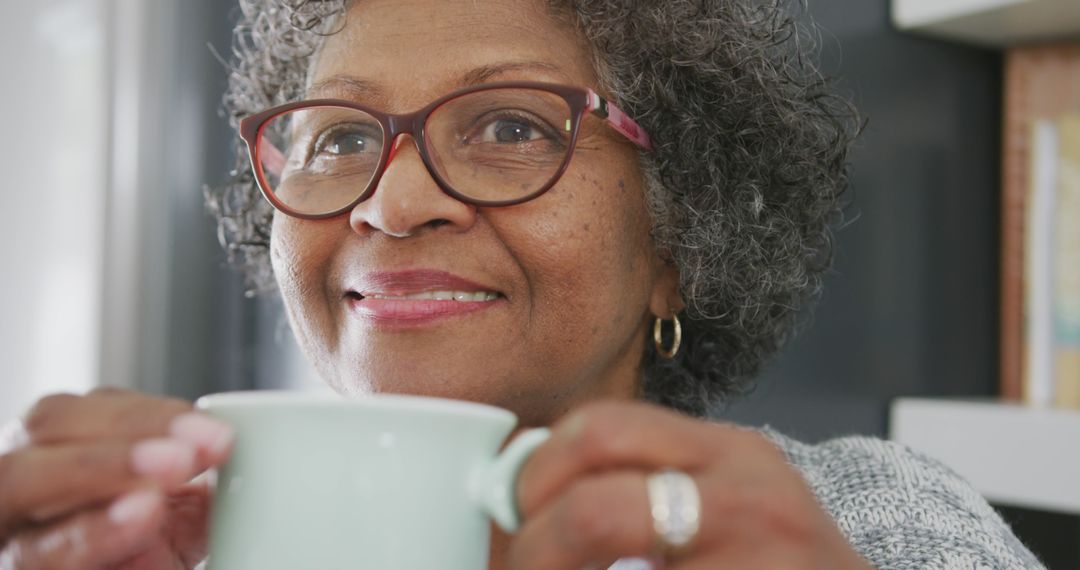 Elderly Woman With Curly Hair and Glasses Holding Coffee Mug - Free Images, Stock Photos and Pictures on Pikwizard.com