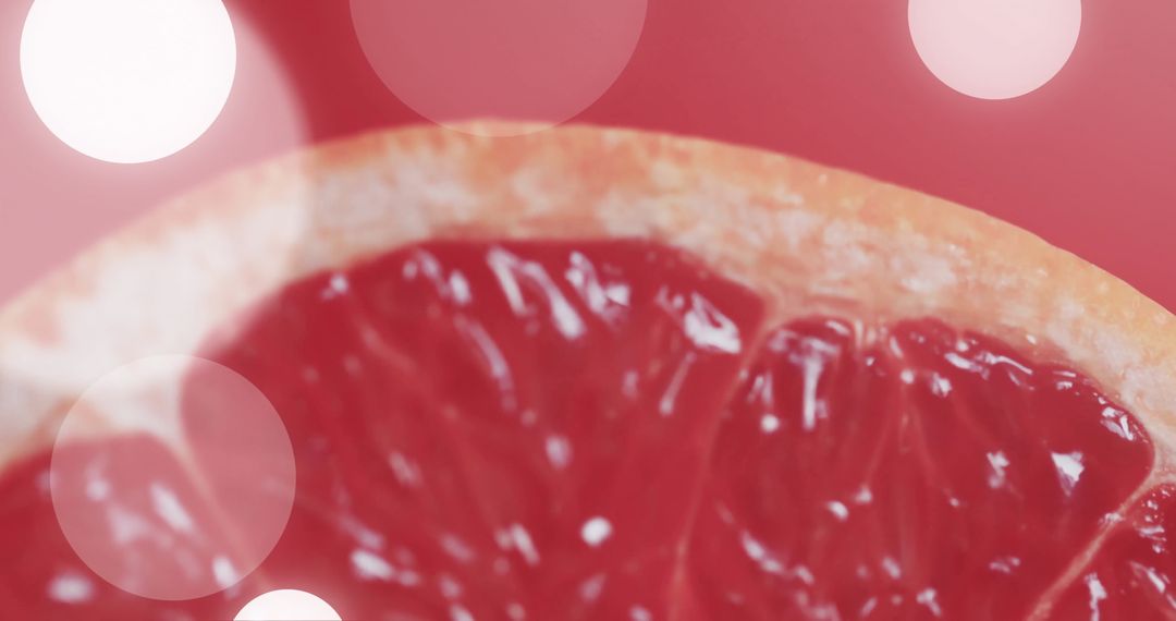 Close-up of Grapefruit Half with Bokeh Lights on Red