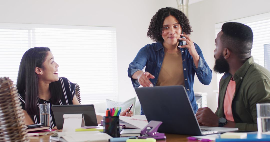Friends Collaborating on Project at Home Desk Setup