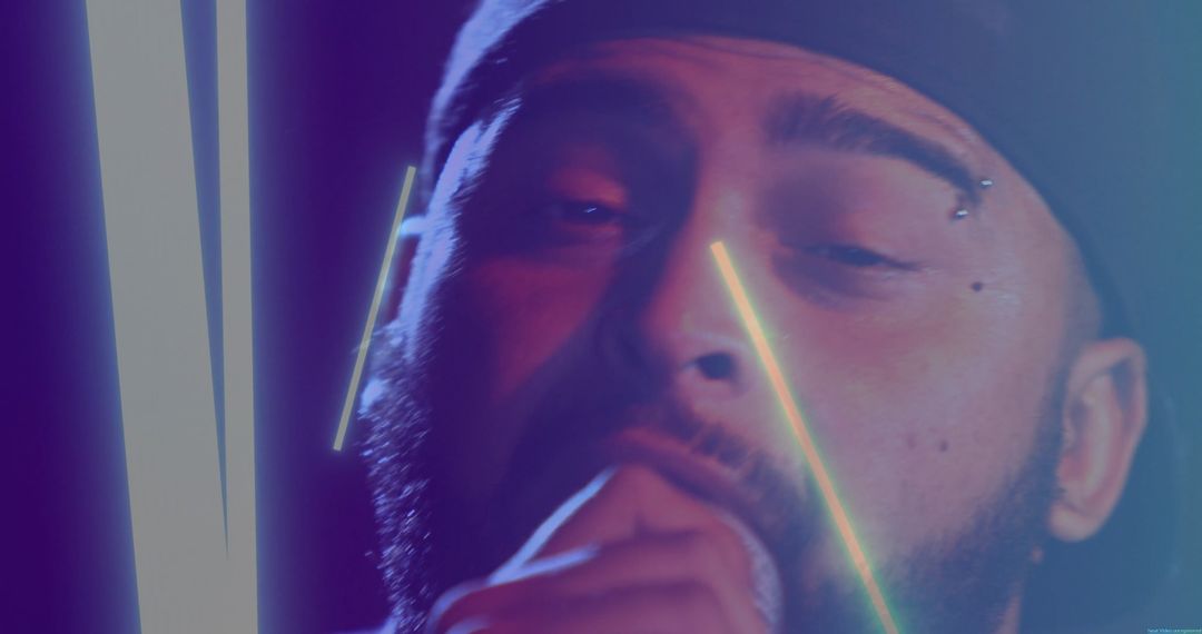 Bearded Man Singing under Neon Lights in Concert