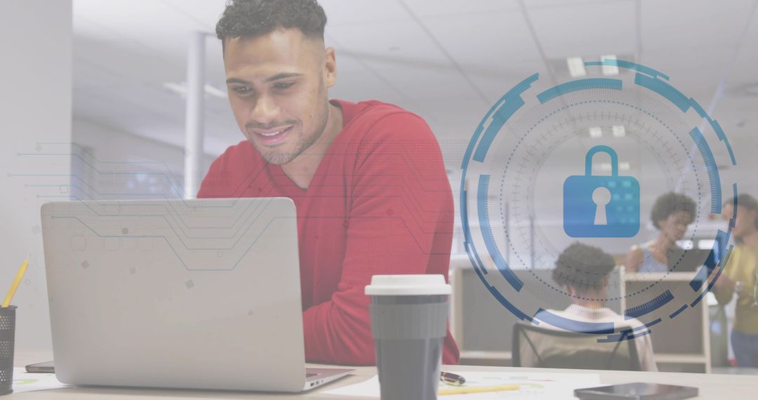 Young professional securing data on laptop with digital padlock overlay in open-plan office