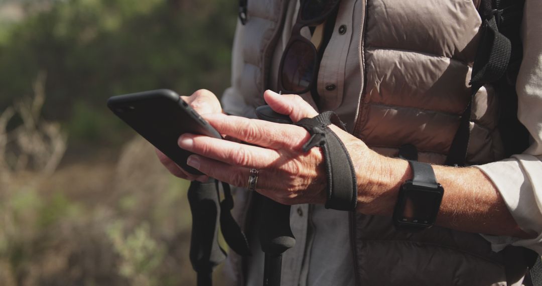 Outdoor Adventurer Using Smartphone for Navigation - Free Images, Stock Photos and Pictures on Pikwizard.com