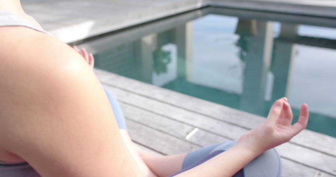 Woman Meditating Near Pool Promoting Mindfulness and Relaxation - Free Images, Stock Photos and Pictures on Pikwizard.com