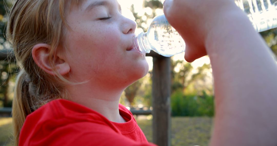 Young Child Enjoying Fresh Water in Park during Golden Hour - Free Images, Stock Photos and Pictures on Pikwizard.com