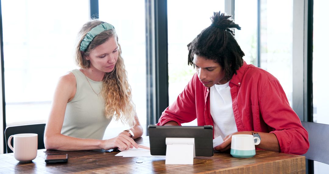 Colleagues Collaborating on Business Project with Tablet in Modern Office