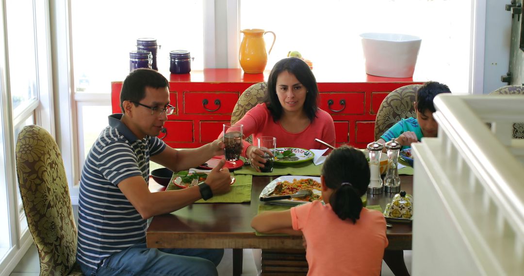 Hispanic Family Enjoying Lunch at Home Together at Dining Table - Free Images, Stock Photos and Pictures on Pikwizard.com