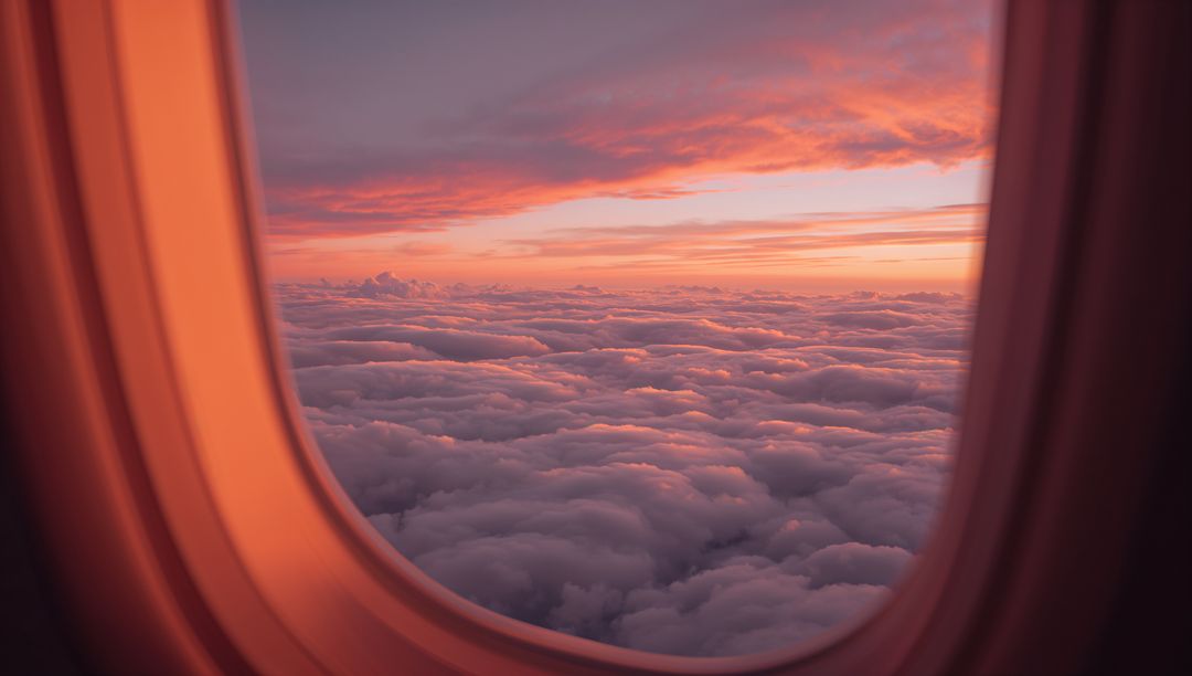 Sunset Cloudscape Viewed Through Airplane Window Framing Warm Pink Orange Lavender