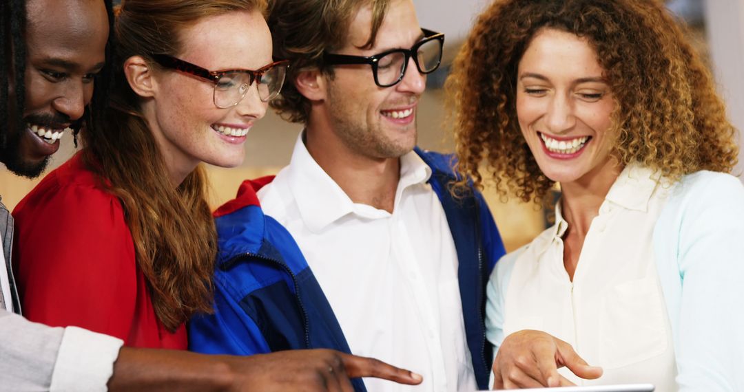 Diverse Young Adults Collaborating with Tablet in Team Environment